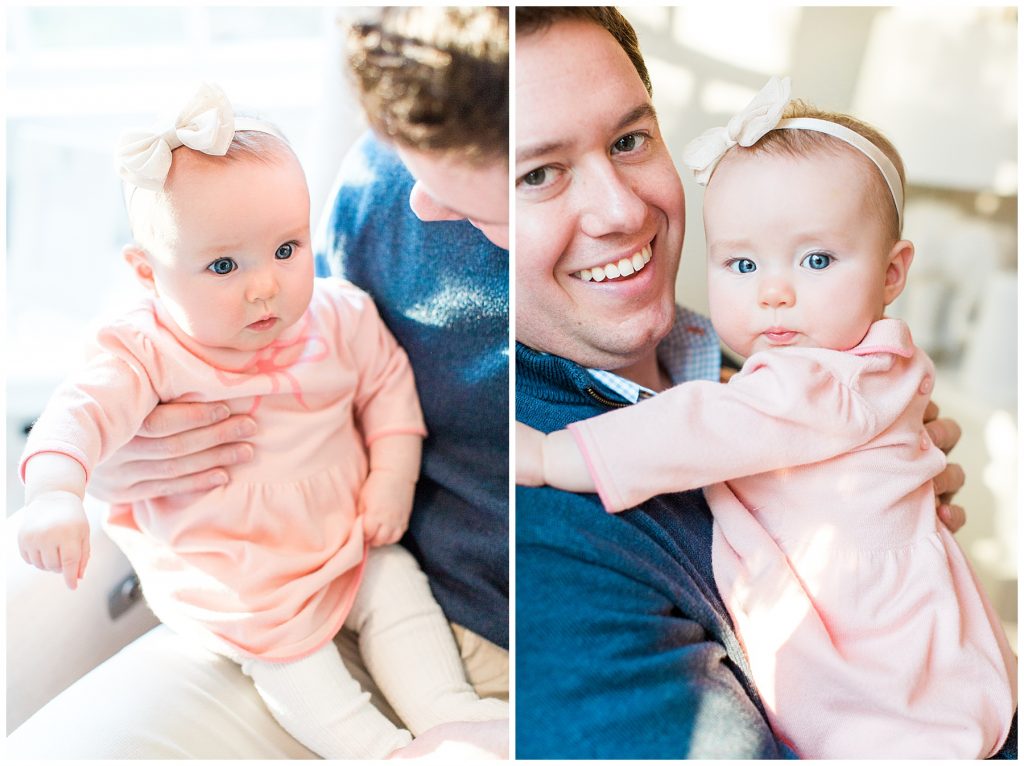 baby girl sitting on her dads lap wearing a pink dress