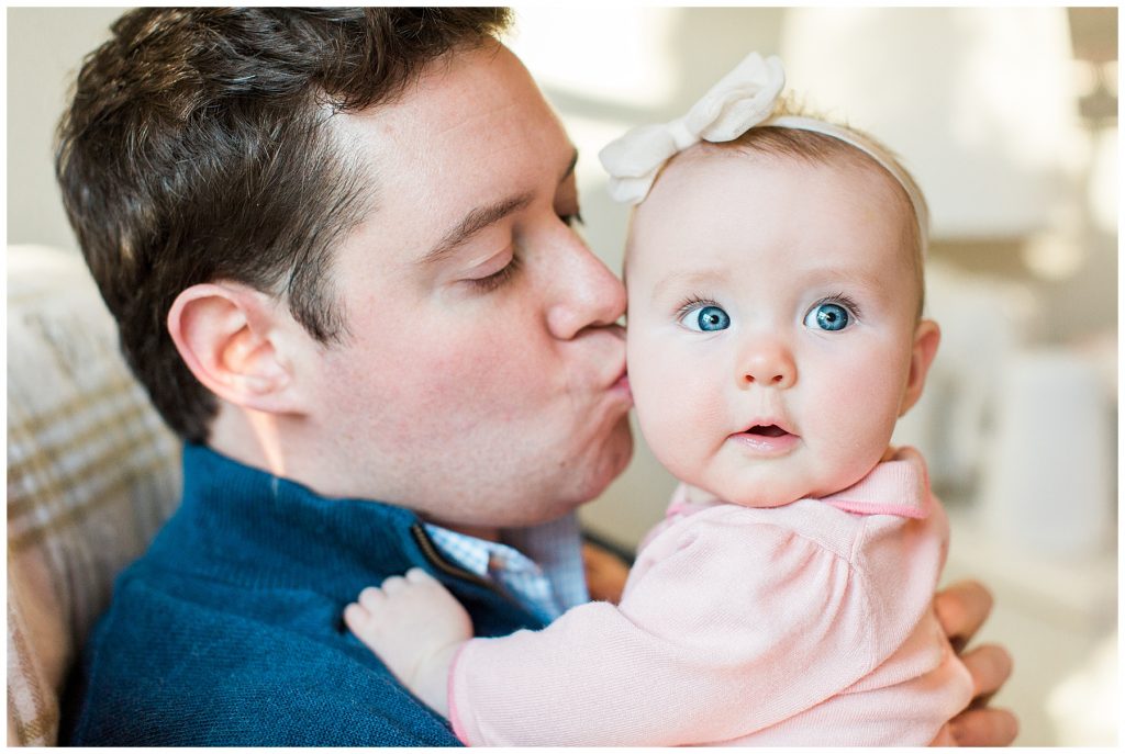 dad kissing his baby girl