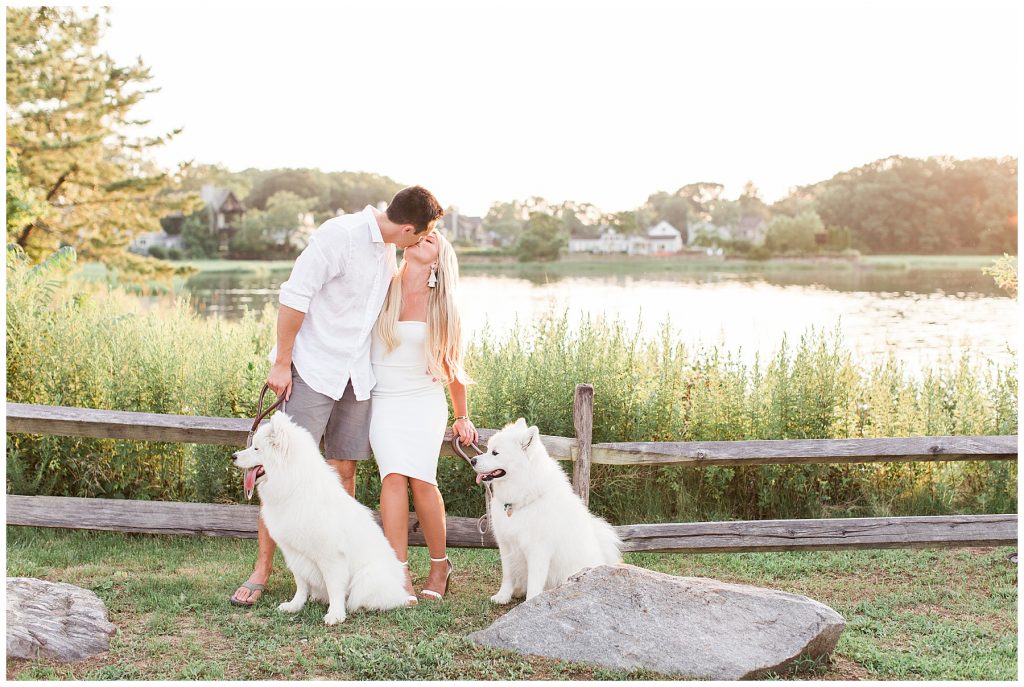 Husband and Wife Kissing for Family Portraits With their dogs