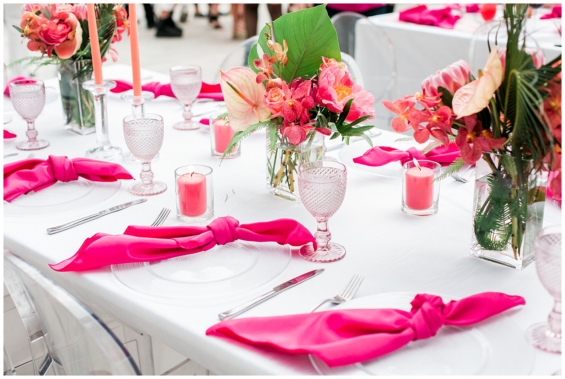bright pink table napkins and bright pink flowers for a party