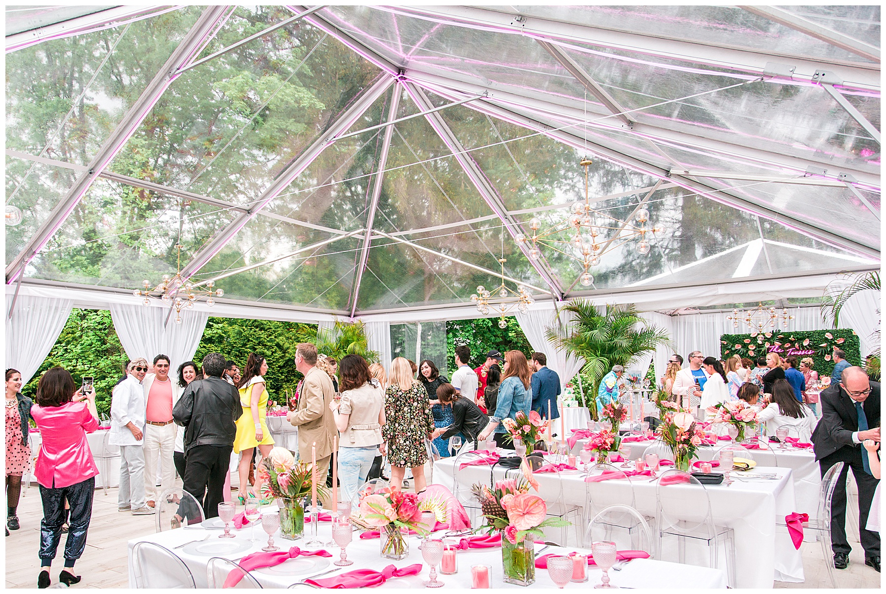 plastic tent with table set up with party guests