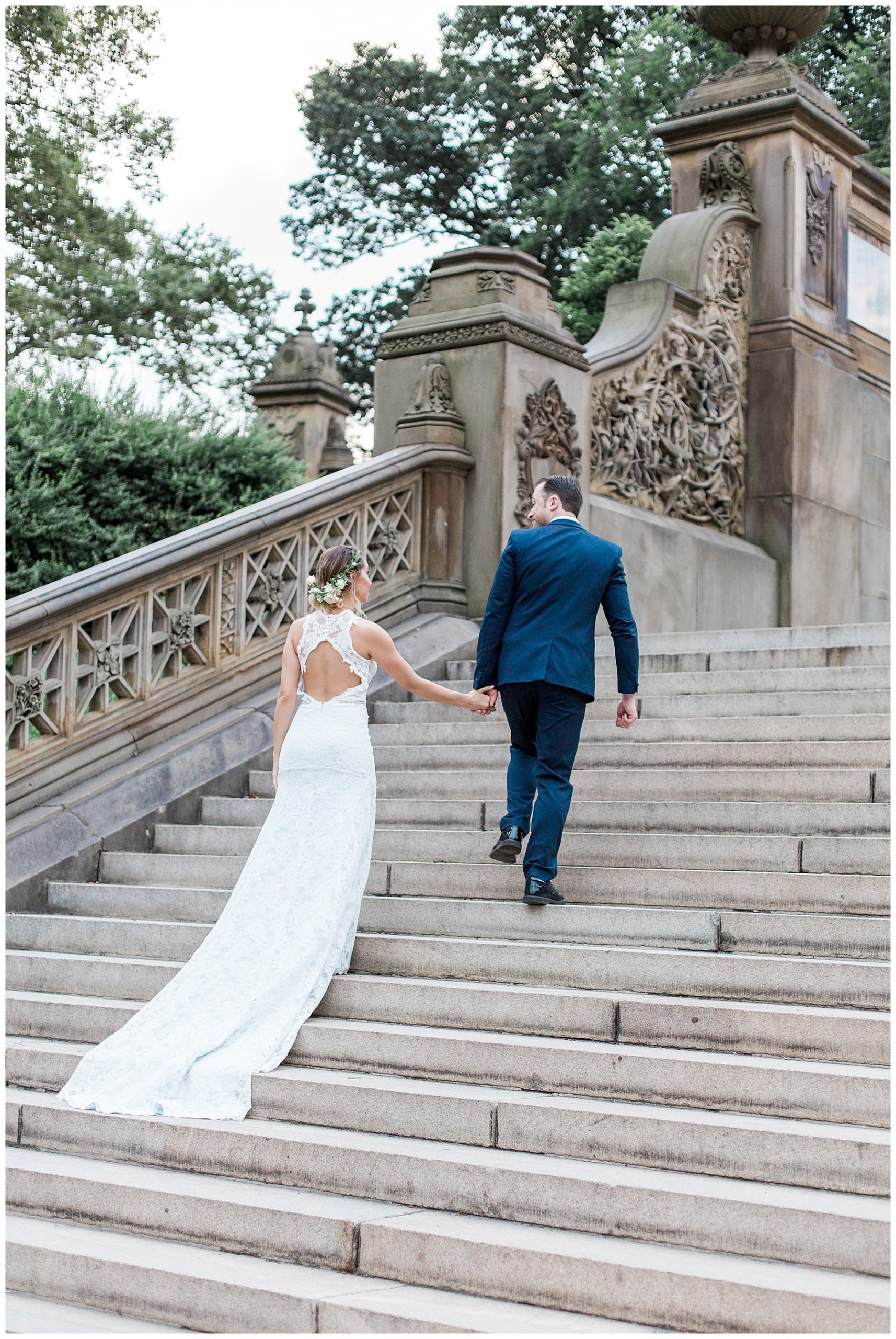 bridal wedding train and bride and groom walking up steps in central park