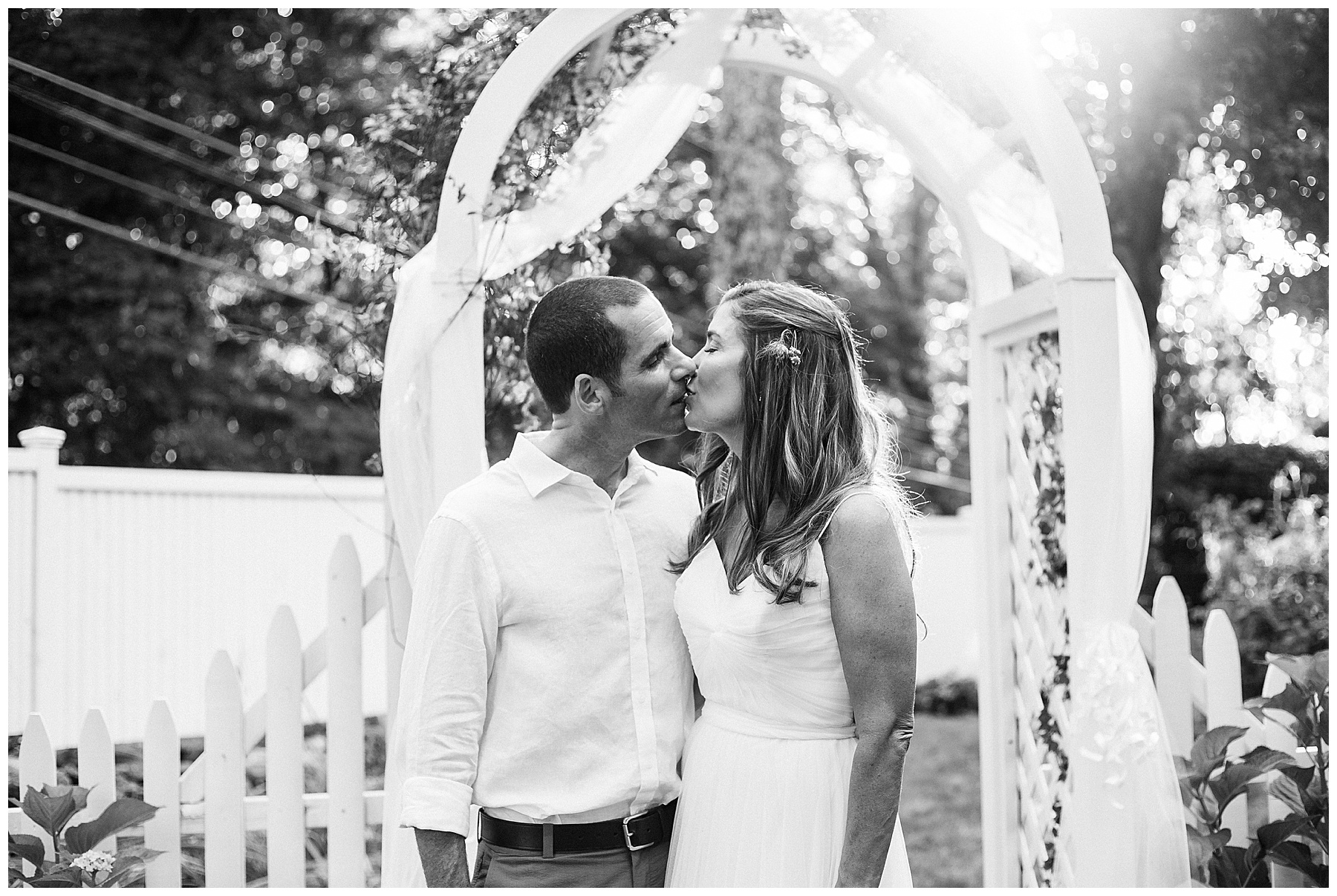 bride and groom kiss during backyard wedding in new canaan Connecticut
