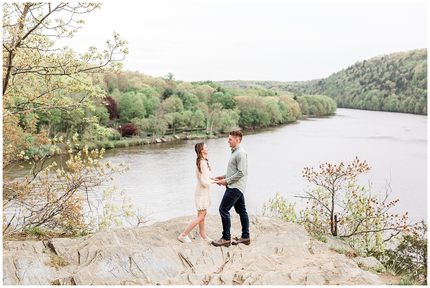 bride-and-groom-standing-on-rock-overlooking-river