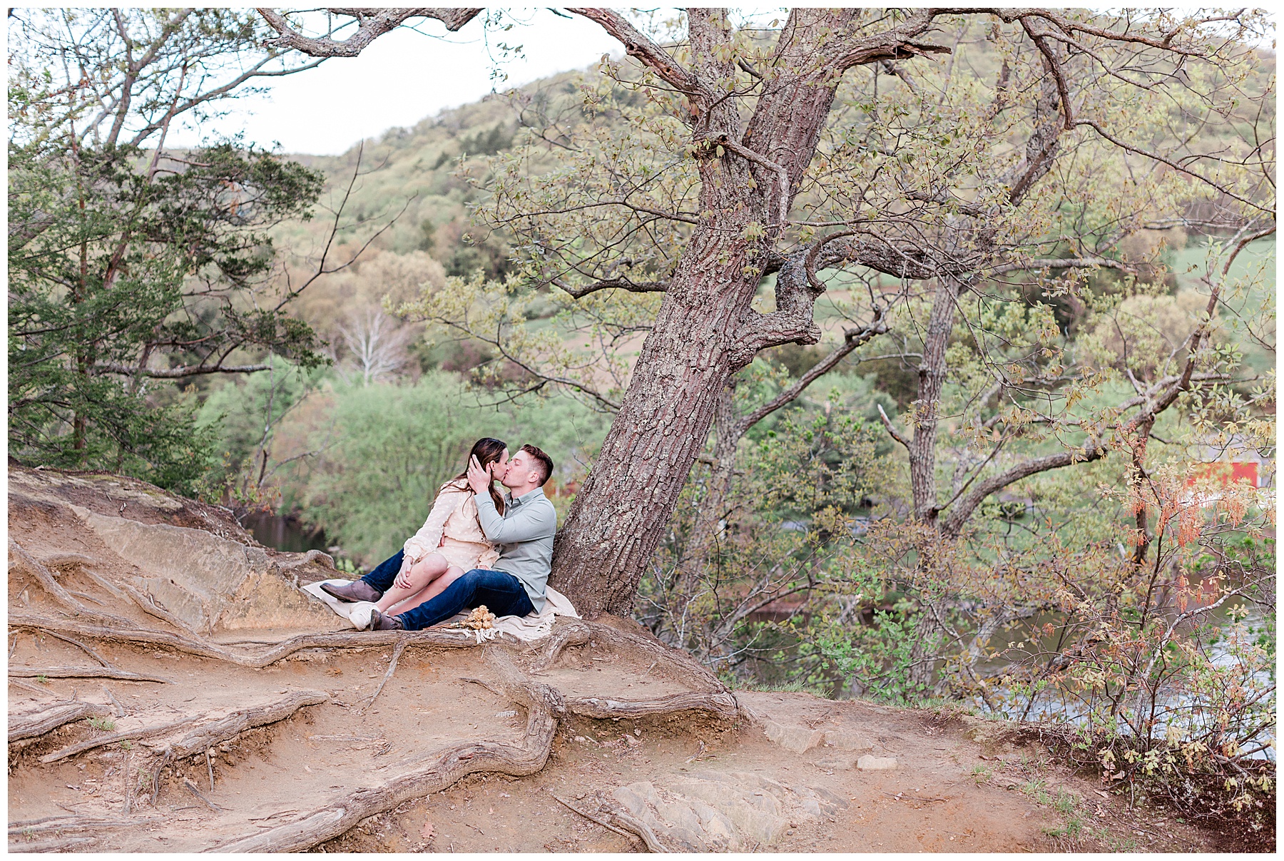 bride-and-groom-sitting-under-a-tree-during-engagement-session