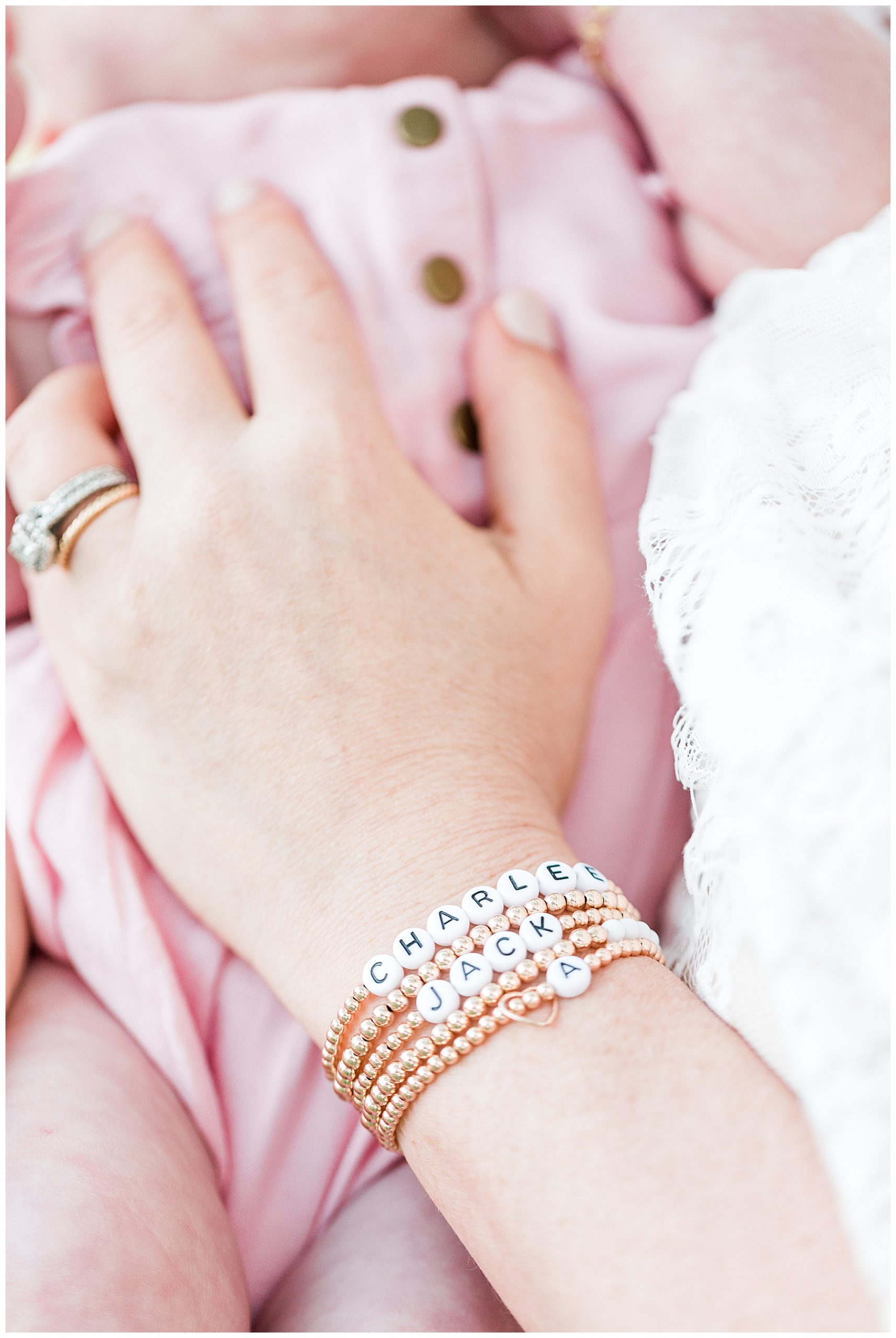Mom-holding-daughter-with-sentimental-bracelets