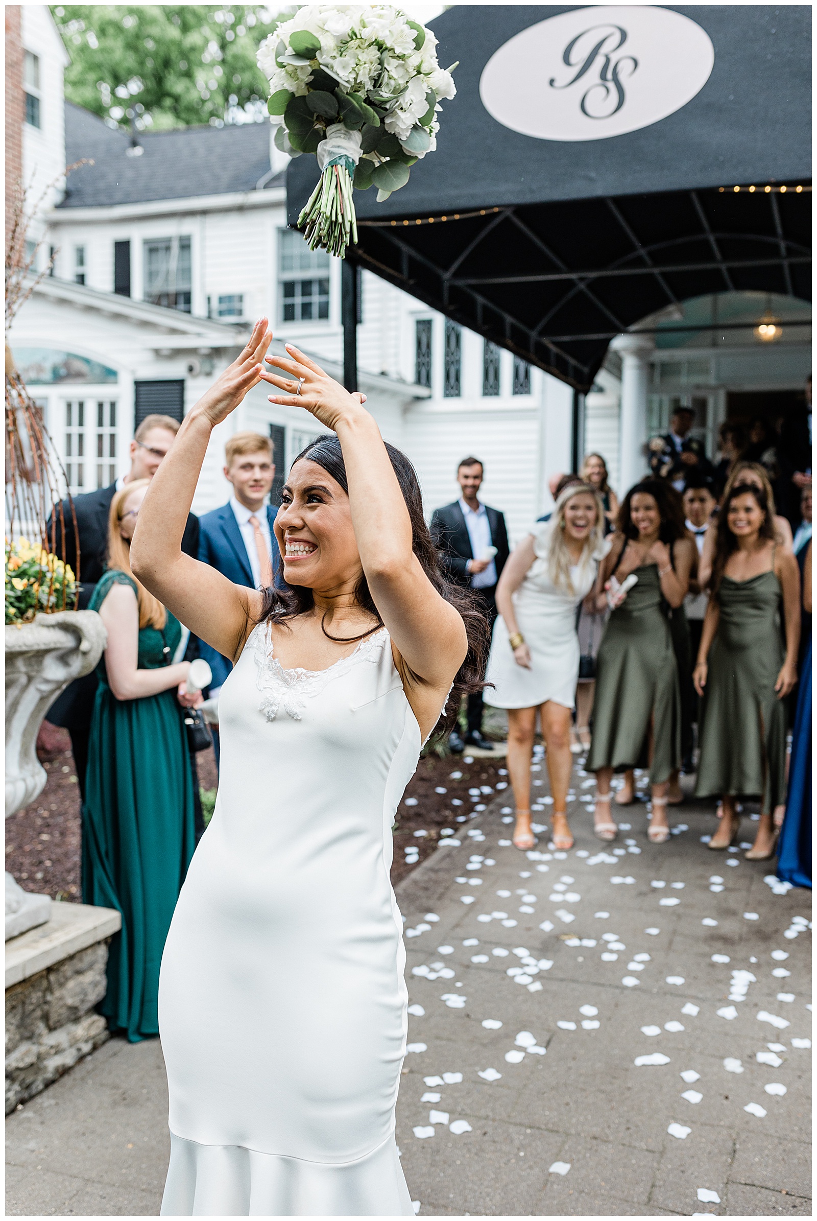 bride-throwing-wedding-bouquet-exit-kristina-staal-photography.jpg