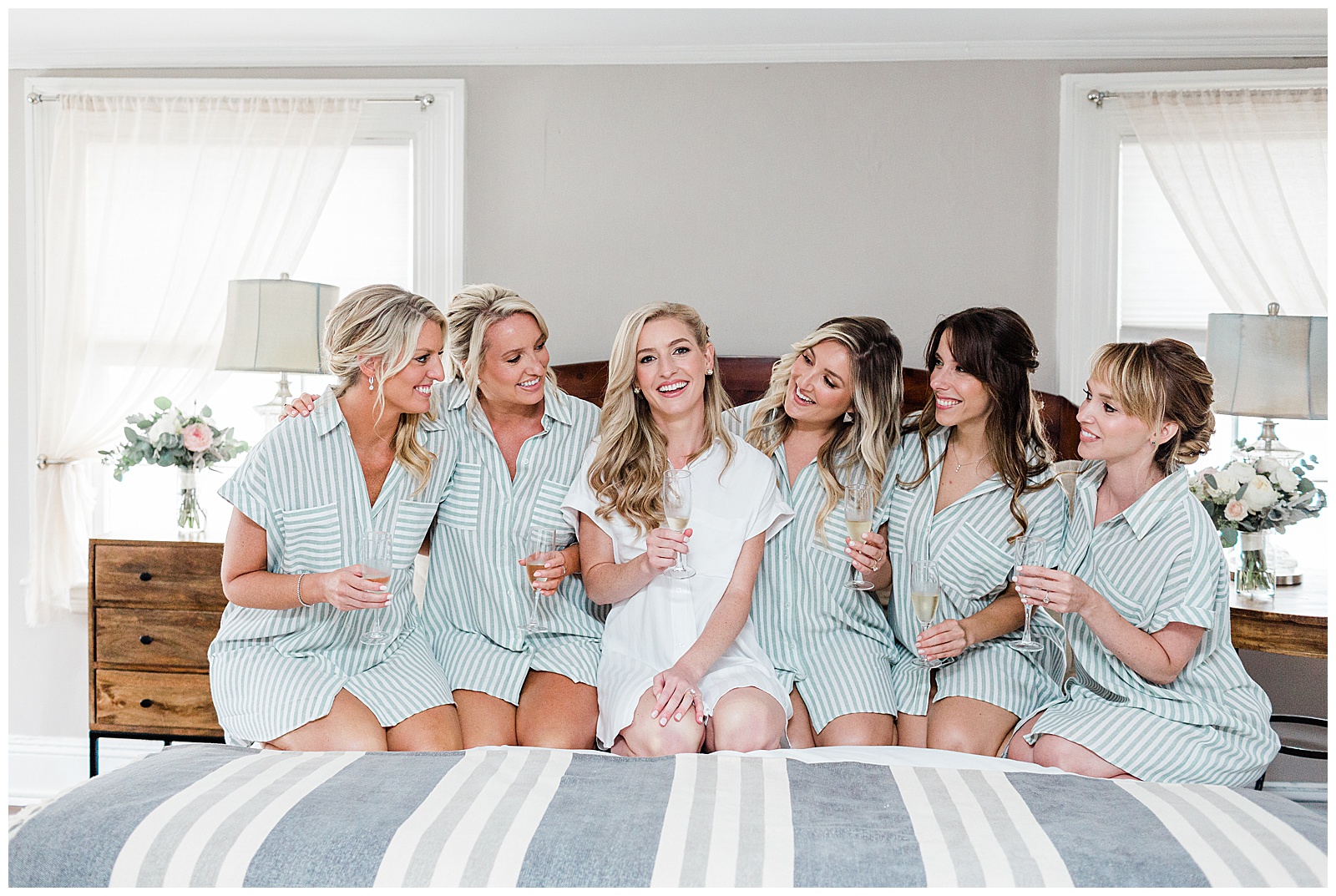 bride-and-bridesmaids-sitting-on-bed.jpg