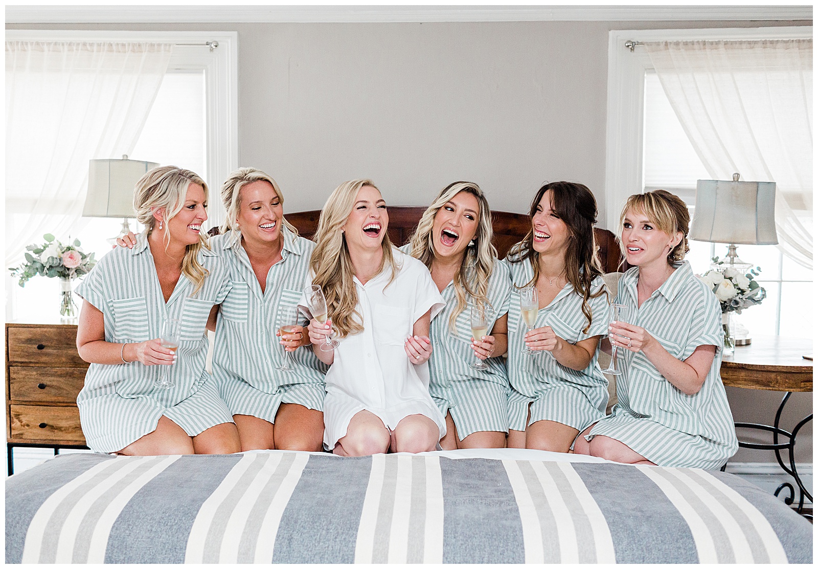 bride-and-bridesmaids-sitting-on-bed.jpg